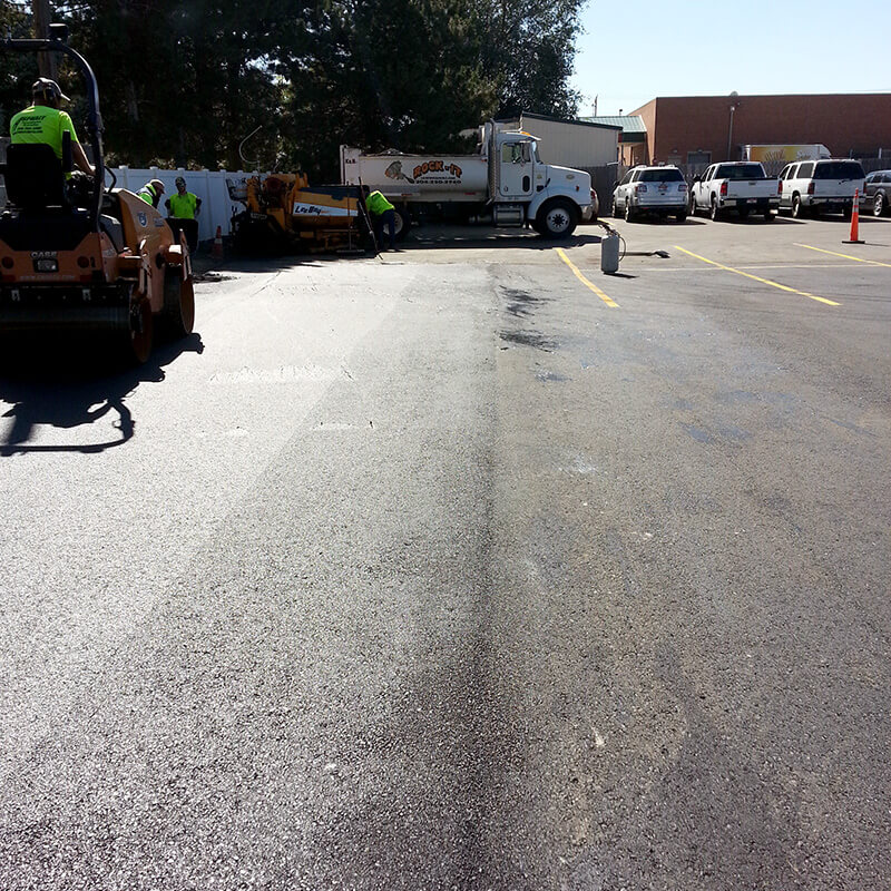 Pavement undergoing Ultra Thin Bonded Wearing Course for treatment.
